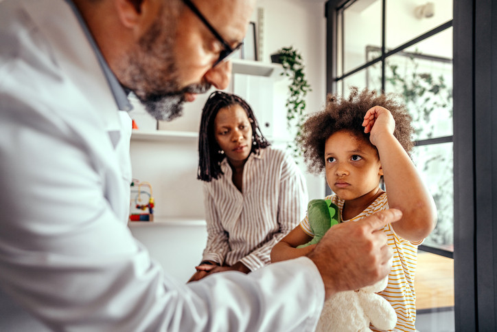 A dermatologist looking at a body fungus